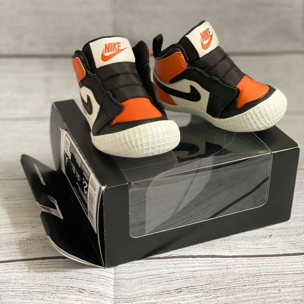 Jordan 1 crib bootie in orange & black. Size 2C.